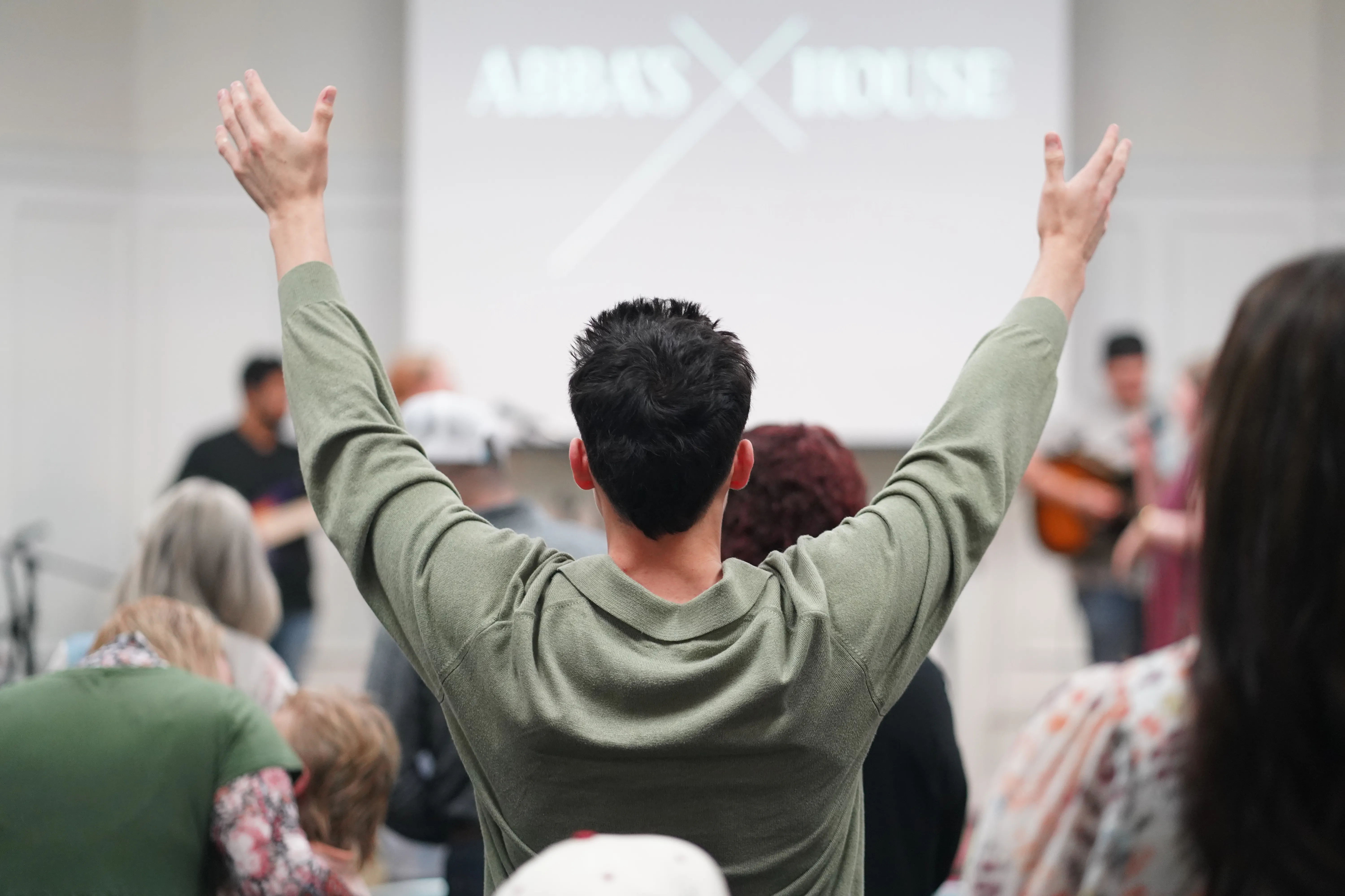 Man worshiping with arms raised