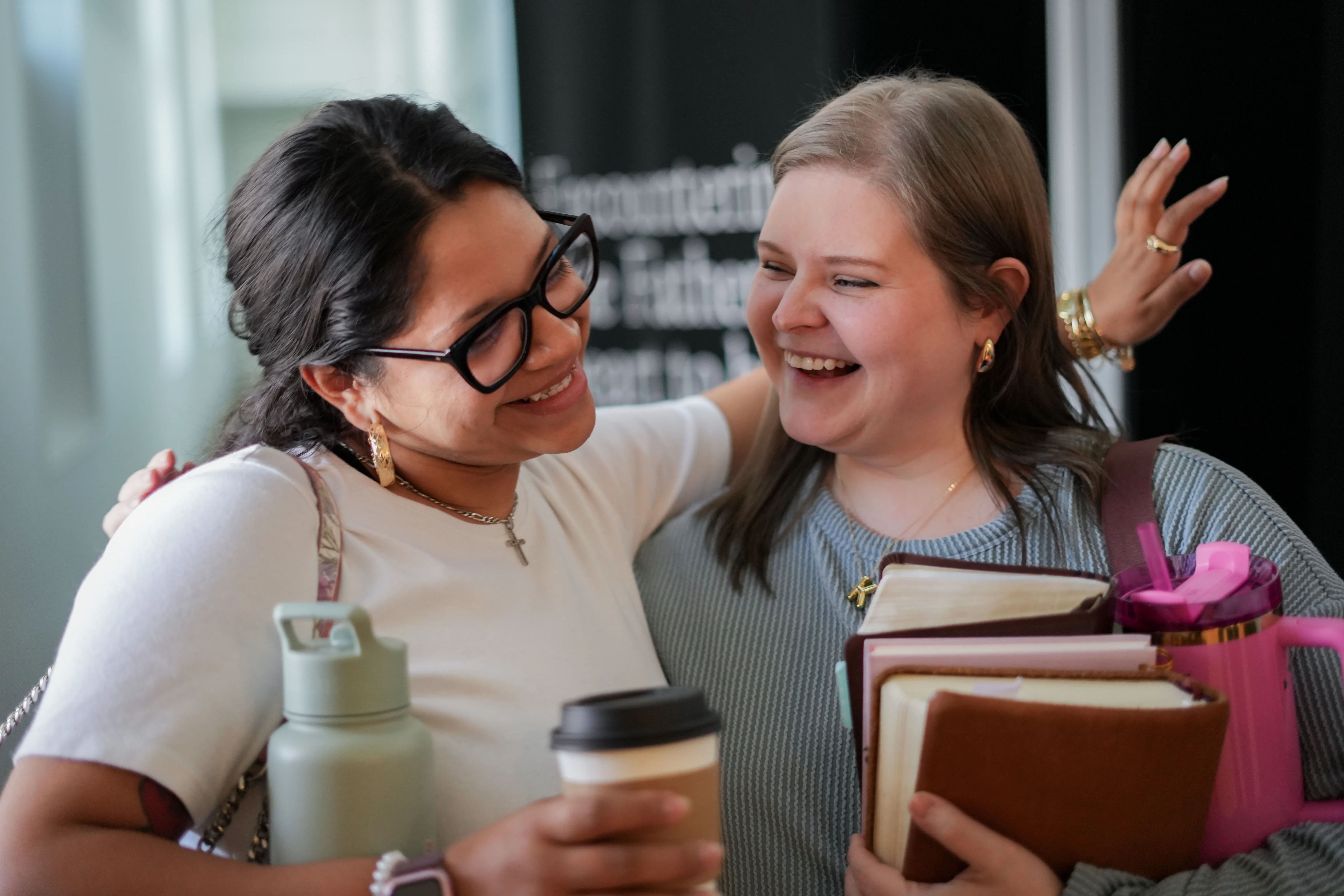 Two women smiling with coffee